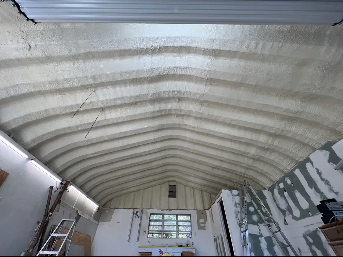Spray polyurethane foam applied to the underside of a metal roof deck in Richardson